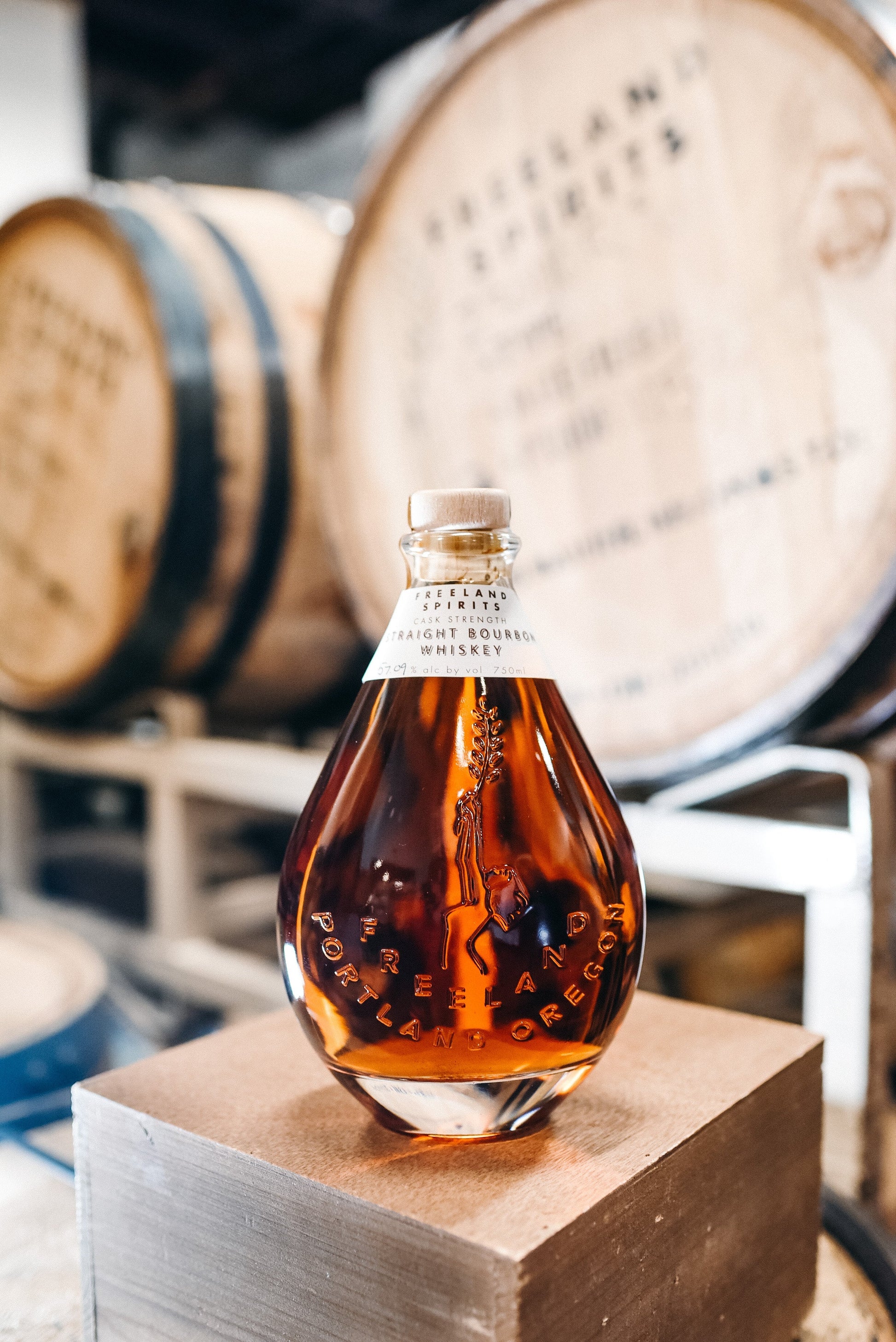 Freeland Cask Strength Bourbon bottle in barrel room at distillery in Portland, OR